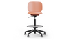 Aarhus Swivel Counter Stool by Quell Design in coral positioned around a modern kitchen island with wooden countertops and pendant lighting. Featuring a smooth moulded polypropylene seat, adjustable gas-lift height, 360-degree swivel, integrated footrest ring, and sturdy five-star base, this Scandinavian-inspired stool blends ergonomic comfort with minimalist contemporary style for residential and commercial interiors.