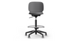 arhus Swivel Counter Stool by Quell Design in black positioned around a modern kitchen island with wooden countertops and pendant lighting. Featuring a smooth moulded polypropylene seat, adjustable gas-lift height, 360-degree swivel, integrated footrest ring, and sturdy five-star base, this Scandinavian-inspired stool blends ergonomic comfort with minimalist contemporary style for residential and commercial interiors.
