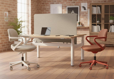 Kubo Contemporary Desk Chairs in coral red and beige displayed together in a modern office interior, featuring tall windows, high ceilings, exposed brick walls and wooden flooring, highlighting ergonomic seating design and contemporary workplace aesthetics.