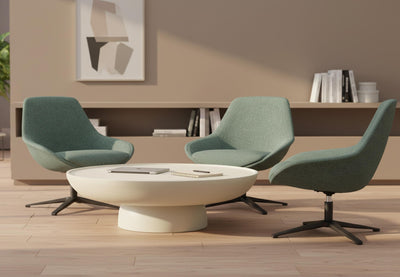  Ørgg Contour Lounge Chairs in green arranged around a coffee table in a modern breakout room, featuring three contemporary lounge chairs set against beige walls, wooden flooring and greenery, highlighting comfortable, design-led seating for office lounges and collaborative spaces.