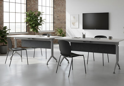 Swish Foldable Conference Tables in white and black in a modern classroom setting. Two tables are placed side by side facing a screen, featuring PET modesty panels, integrated water, pen holders and name card slots, providing flexible and functional seating for training and collaborative environments. 