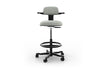 Tulip Adjustable Swivel Stool with integrated armrest and ergonomic support features, available in dark grey, light grey, orange and green. Designed with an adjustable backrest, sliding seat and tilting back support to encourage movement and reduce fatigue, it includes a smooth swivel function and round steel footrest for stability in modern offices and collaborative workspaces.