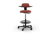 Tulip Adjustable Swivel Stool with integrated armrest and ergonomic support features, available in dark grey, light grey, orange and green. Designed with an adjustable backrest, sliding seat and tilting back support to encourage movement and reduce fatigue, it includes a smooth swivel function and round steel footrest for stability in modern offices and collaborative workspaces.